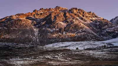 Majestic snow-dusted mountains in Lanzada, Italy captured at sunset with vivid colors.