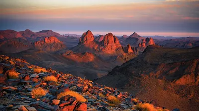 Capture the breathtaking sunset across the rocky terrains of Tamanrasset, Algeria.