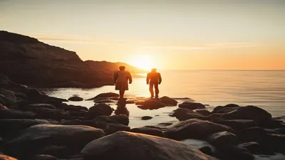 Reflective figure on rocky shoreline.