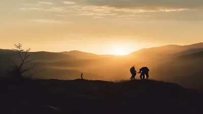 Silhouette in mountain landscape at sunrise.